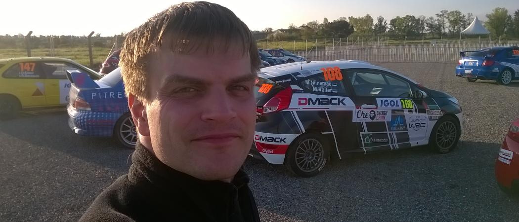 Photo of Hannes Tõnisson in front of a rally car
