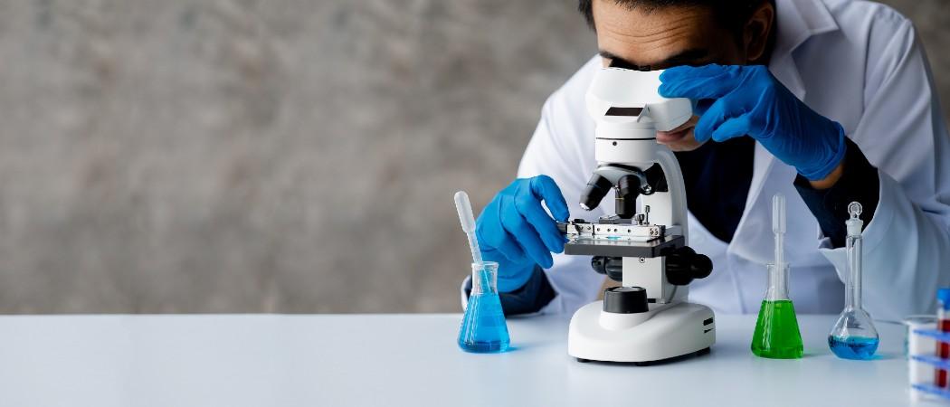 Scientist looking through a microscope