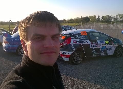 Photo of Hannes Tõnisson in front of a rally car